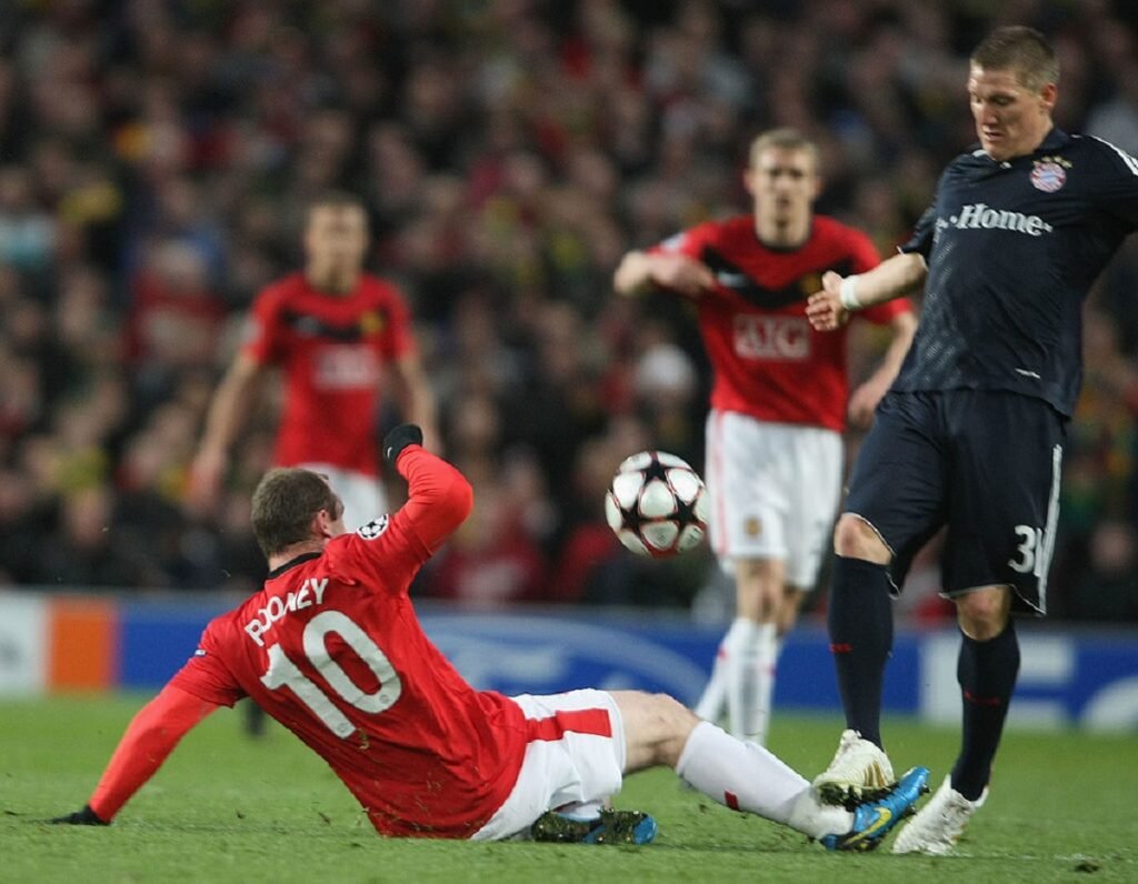 Wayne Rooney challenges for the ball.